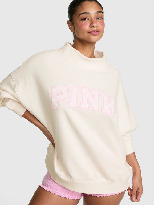Oversized Mock-Neck Sweatshirt in soft cream with varsity graphic.