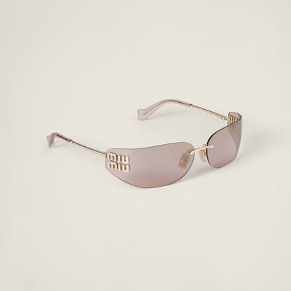 Close-up of the gold hardware detail on the Aube Sunglasses frame.